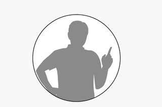 片手を腰に置き、片指を円の中に上げている人のシルエット。