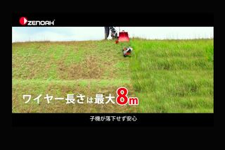 ゼノアのロゴが見える急斜面で草刈りをするリモコン芝刈り機。